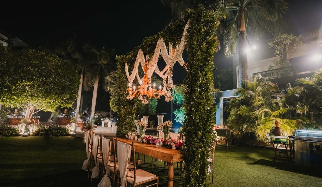 Lawn dinner under a floral chandelier